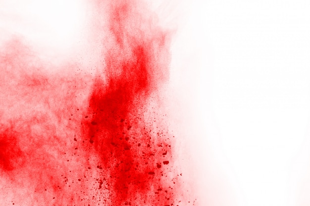 Freeze motion of red powder exploding, isolated on white background.  