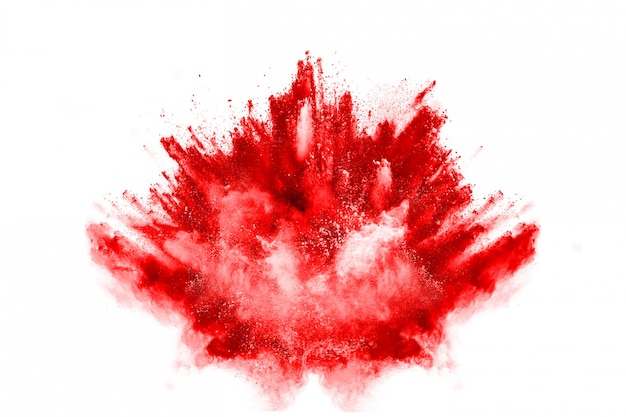 Photo freeze motion of red powder exploding, isolated on white background