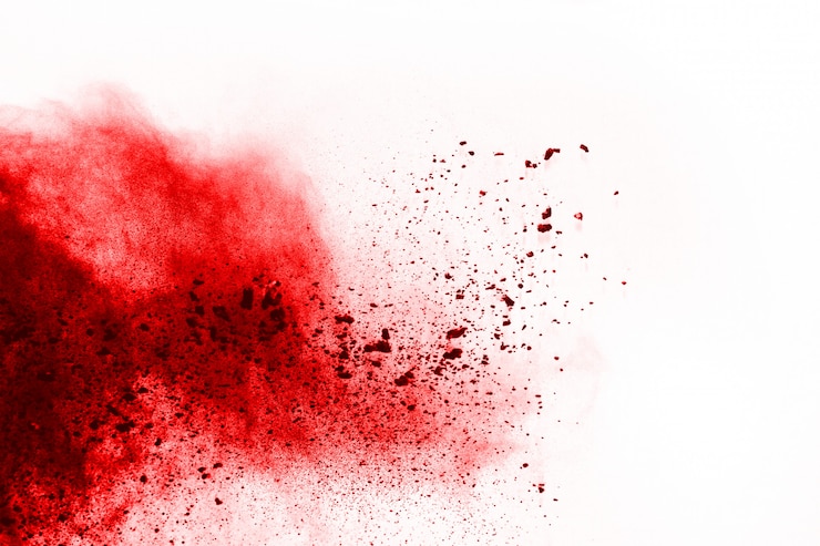 Photo freeze motion of red powder exploding, isolated on white background.  
