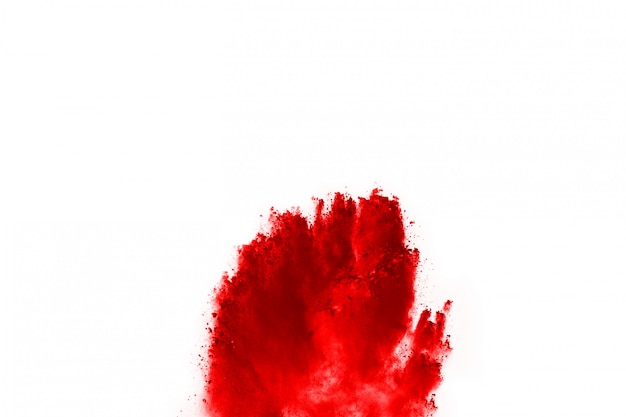 Freeze motion of red powder exploding, isolated on white background.  