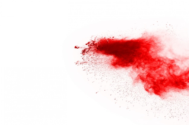 Freeze motion of red powder exploding, isolated on white background.  