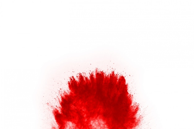 Freeze motion of red powder exploding, isolated on white background.  