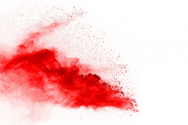 Freeze motion of red powder exploding, isolated on white background.  