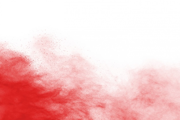 Photo freeze motion of red powder exploding, isolated on white background.