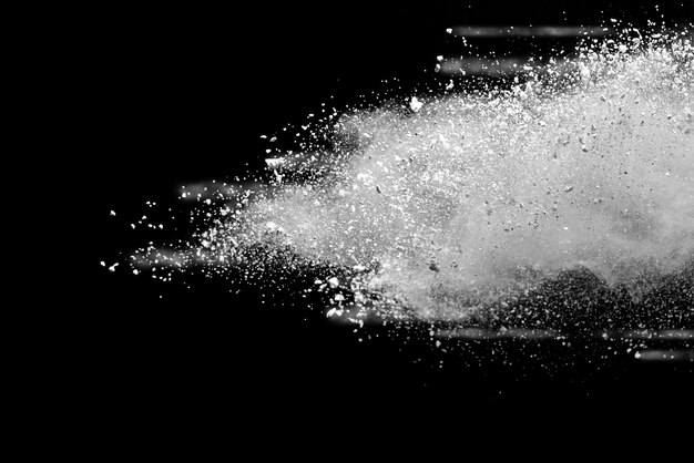 Freeze motion of white powder explosions isolated on black background.