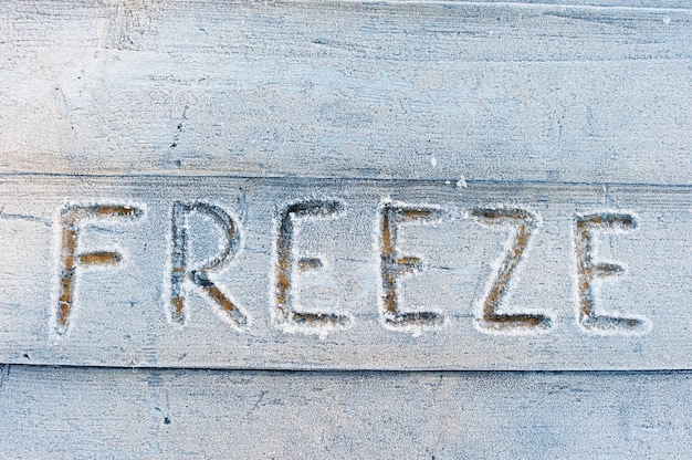 Freeze written on a wooden flor with frosts