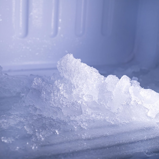 The freezer compartment of the refrigerator has a lot of ice on it