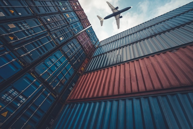 Freight airplane flying above overseas shipping container