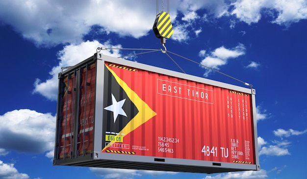 Freight shipping container with national flag of East Timor hanging on crane hook 3D illustration