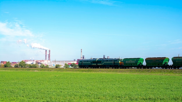 Freight train, Belaruskali hopper wagon with edible salt from largest Belarus producers of potash fertilizers in the world. Cargo train delivers goods. Export of edible salt