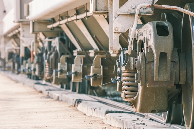 Freight train wheels on a siding next to a factory in industrial area