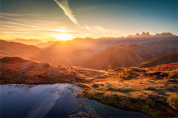 French alps landscape of sunrise shines over lac guichard with arves massif in autumn at aiguilles darves france