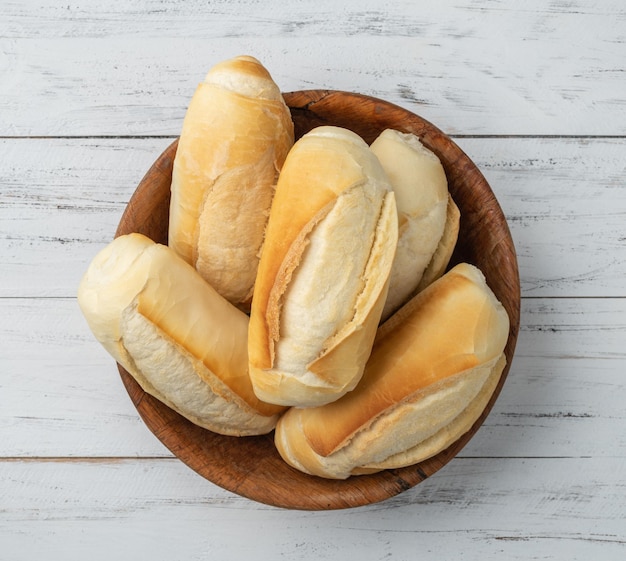 French bread salt bread or pistolet in a bowl over wooden table