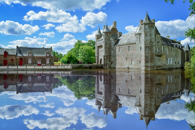 French Brittany village on a sunny day. Clastle reflect in the lake. Franc