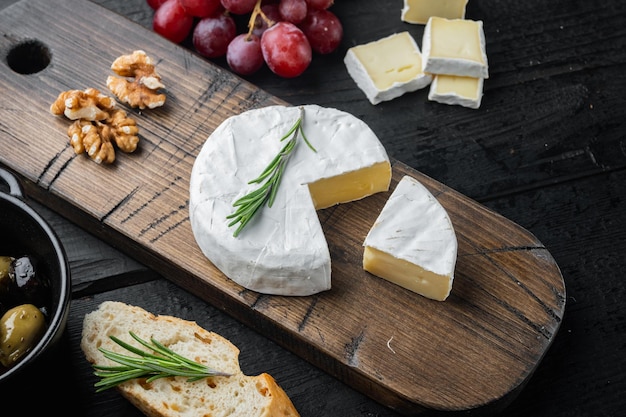 French camembert cheese set on black wooden table