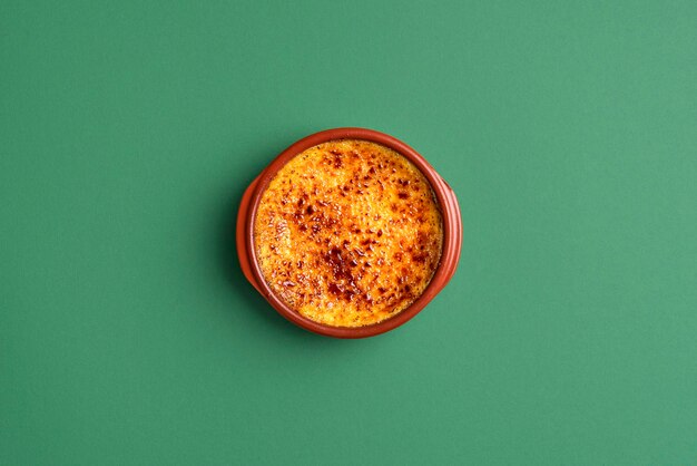 French creme brulee with burnt sugar in clay tray fine custard dessert