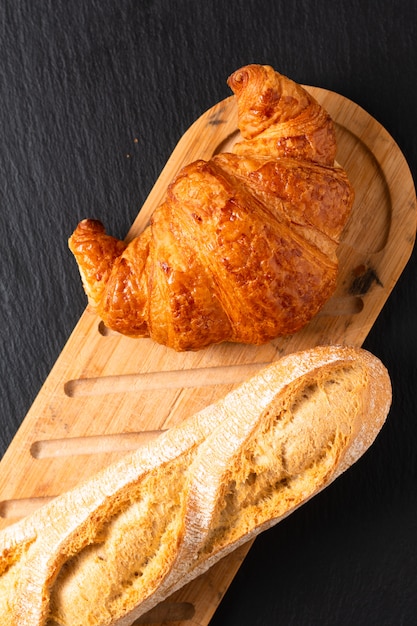 French croissant on black slate board with copy space