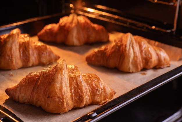 French croissants being baked in the oven.