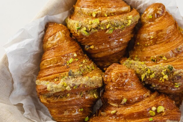 French croissants in wicker basket on table