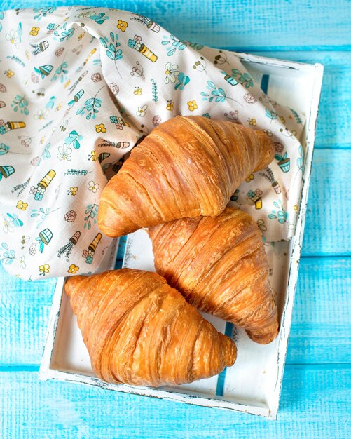 French cuisine Croissants on a blue background Bakery products French croissant sweet bun