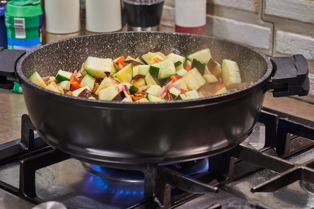 French cuisine ratatouille salad in frying pan on gas stove