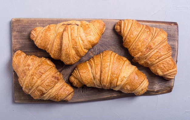 French delicious breakfast croissants on wooden background