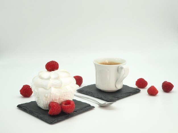 French dessert Merengue with raspberries and black coffee Closeup