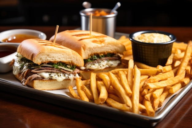 French dip sandwich served with crispy fries on a tray