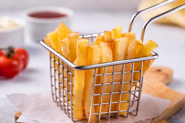 French fries in a basket on  concrete