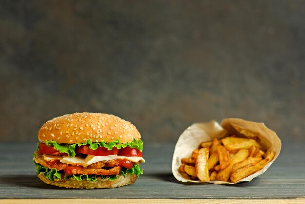 French fries and delicious and juicy burge in a rustic style