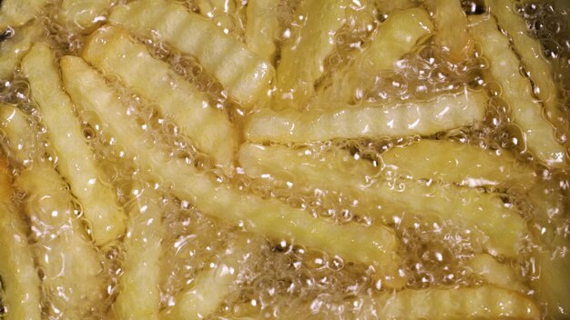 French fries frying in hot oil.