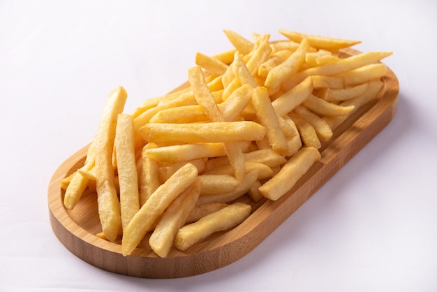 French fries placed on a long wooden plate.