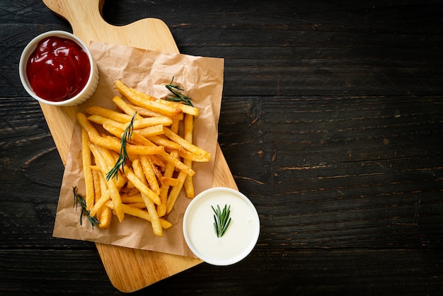 French fries or potato chips with sour cream and ketchup