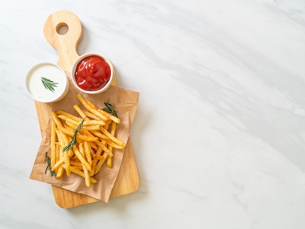 French fries or potato chips with sour cream and ketchup