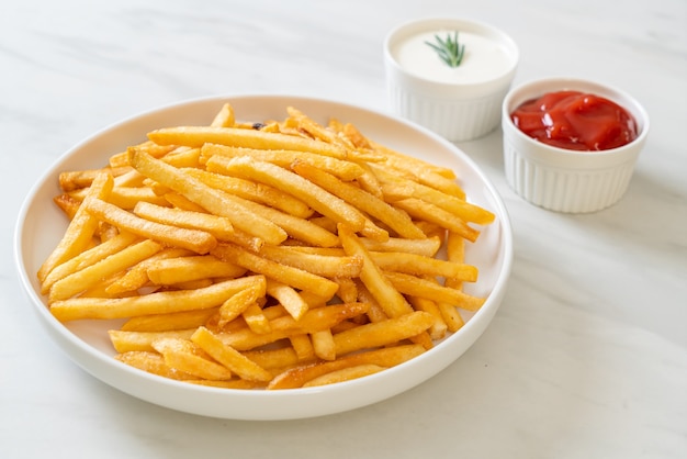 French fries or potato chips with sour cream and ketchup