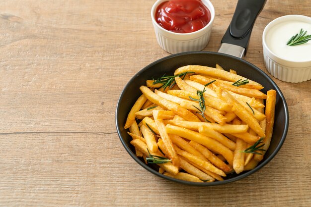 French fries or potato chips with sour cream and ketchup