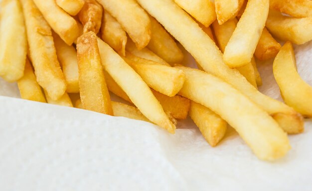 French fries on white paper.