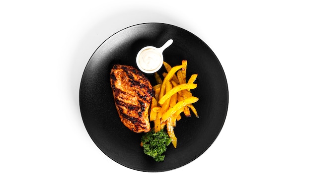 French fries with grilled chicken fillet isolated on a white background