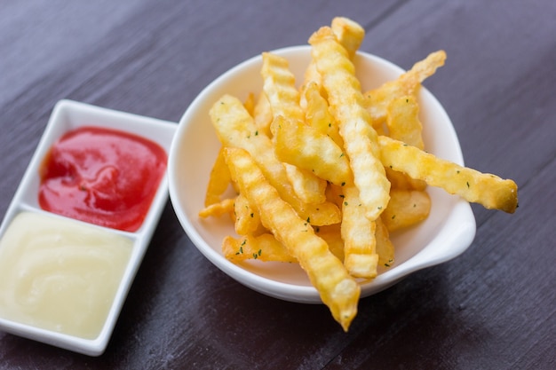 French fries with ketchup on wood