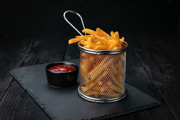 french fries with sauce on a dark background