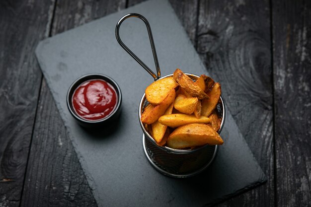 french fries with sauce on a dark background