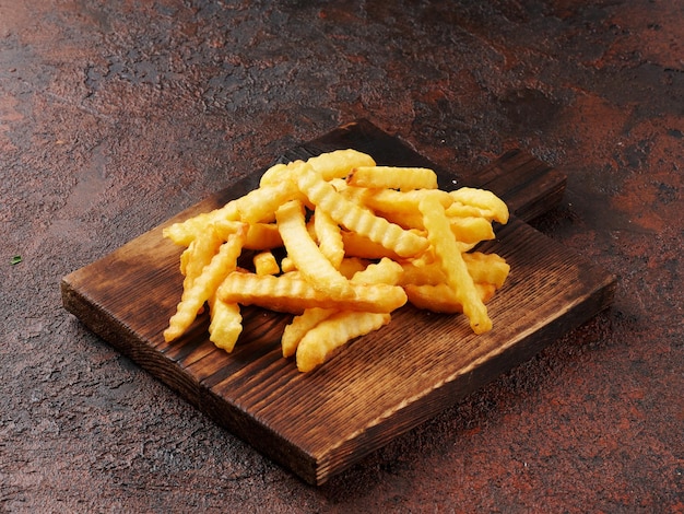 French fries on a wooden board