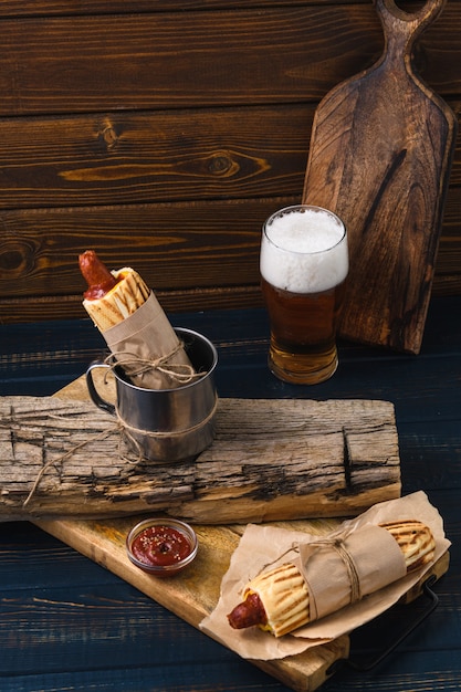 French hot dog with beer in rustic style. Street food.