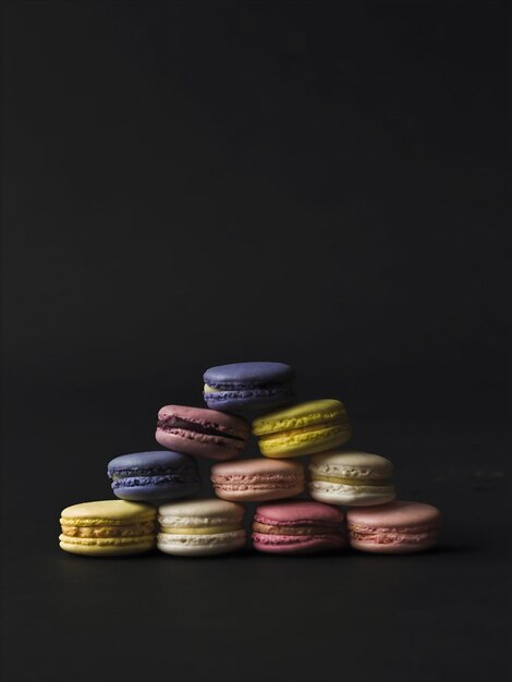 French macaron or macaroon on different background from above colorful almond cookies pastel color