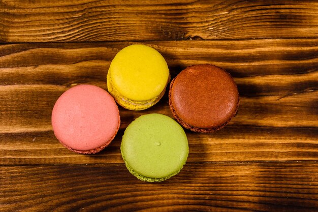 French macaroons on a rustic wooden table. Top view