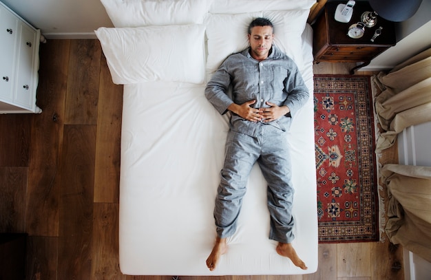 French man sleep alone on bed