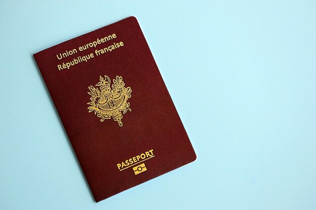 Photo french passport on blue background close up tourism and citizenship concept