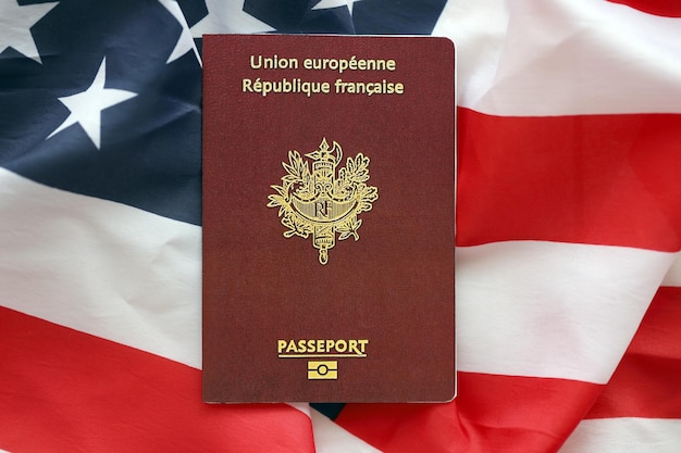 French passport on united states national flag background close up tourism and diplomacy concept