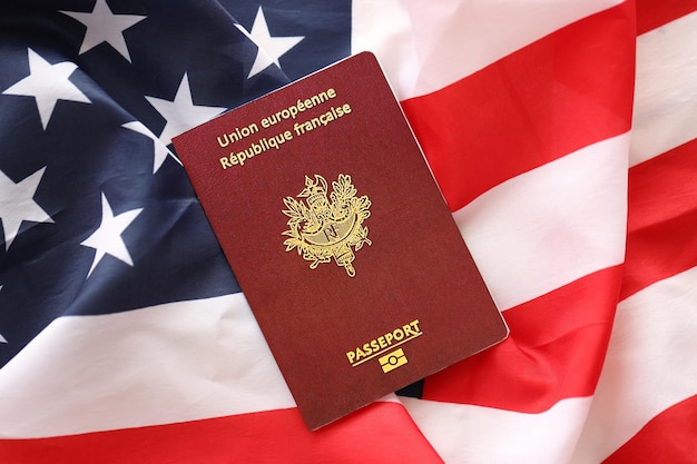 Photo french passport on united states national flag background close up tourism and diplomacy concept