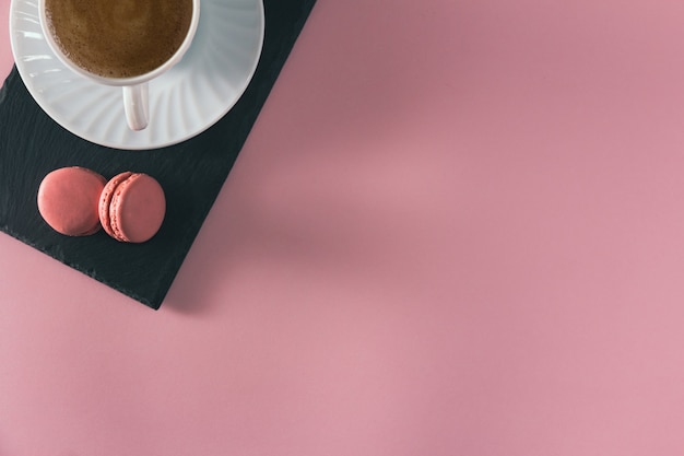 French pastel colored macarons dessert with coffee cup Copy space Selective focus